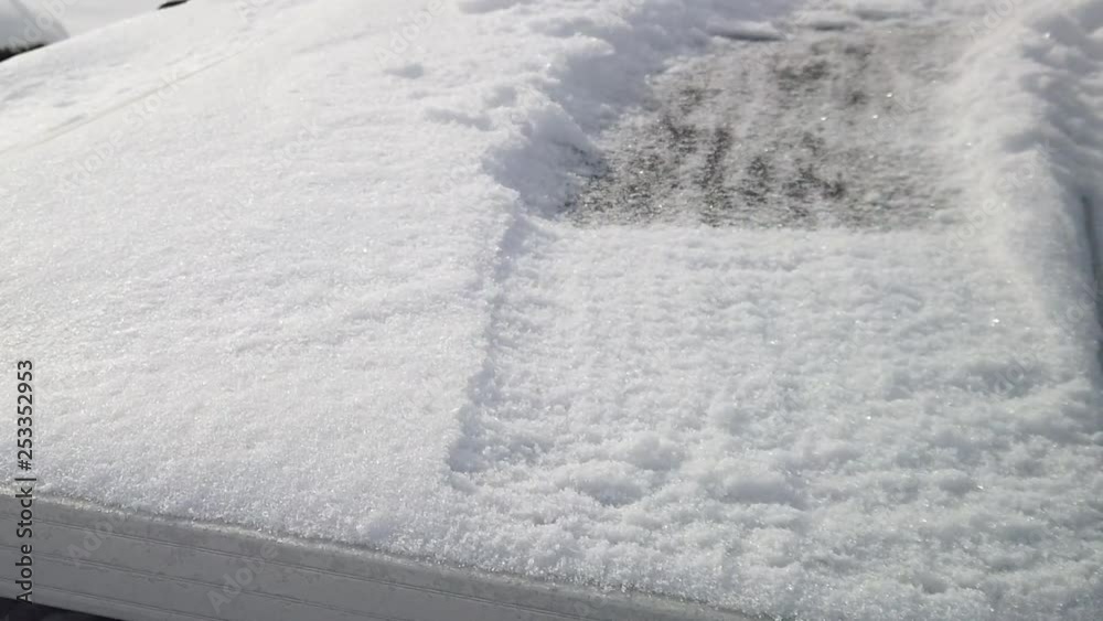 Someone brushing snow off of a solar panel at half speed Someone brushing snow off of a solar panel at half speed