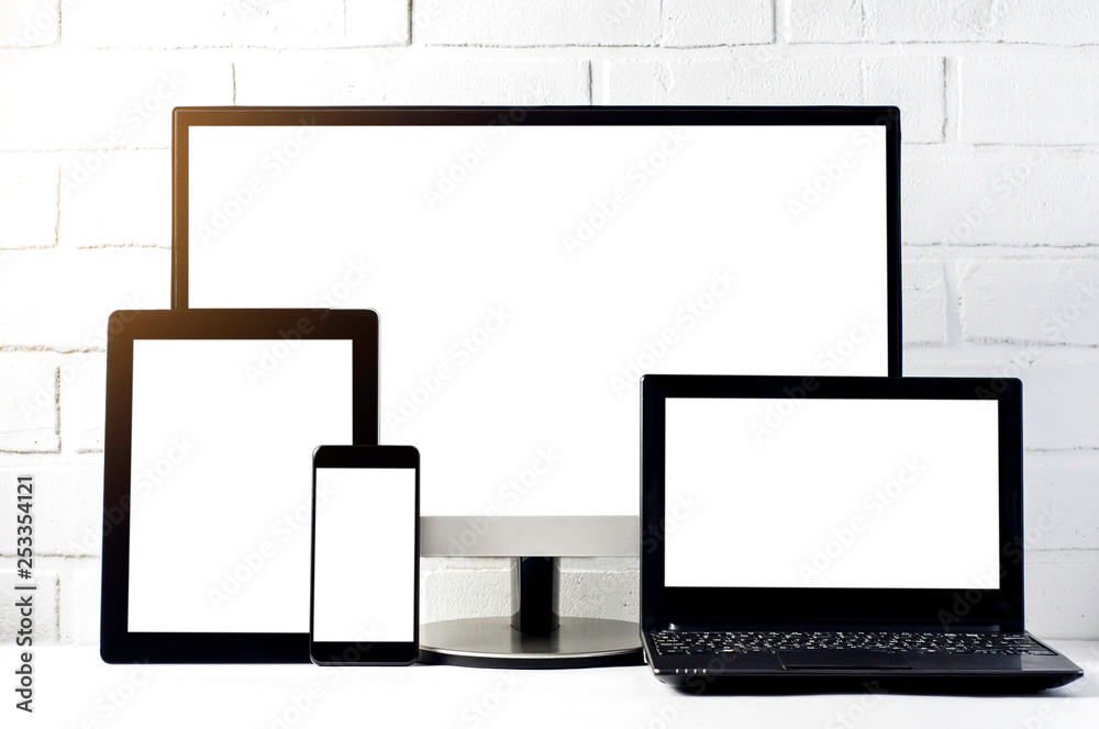 Monitors and tablets on a light background. Template for text or design of the website Monitors and tablets on a light background. Template for text or design of the website
