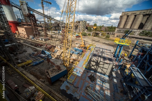 landscape, panorama, view of factory slums with metal hulls and machines for the production of the coking industry, smoking pipes and reconstruction of a plant in Ukraine