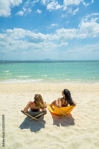 Fototapeta Naklejka Na Ścianę i Meble -  Two Women enjoying their holidays on the tropical beach