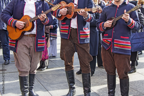 Traditional Croatian musicians in Slavonian costumes play in the city square photo