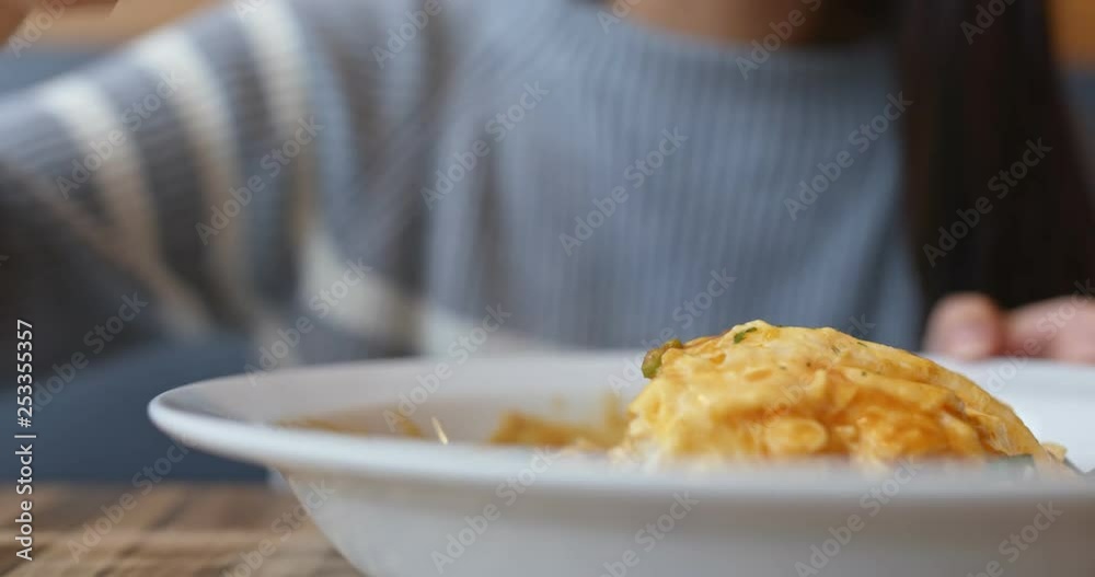 Woman enjoy the omelette curry rice Woman enjoy the omelette curry rice