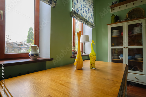 beautiful modern interior in the kitchen with flowers and vases, red, yellow and green colors dominate