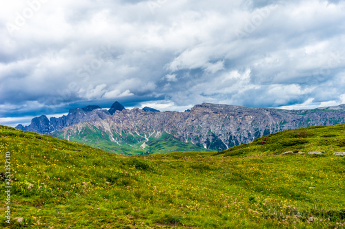 Alpe di Siusi, Seiser Alm with Sassolungo Langkofel Dolomite, a large green field with a mountain in the background