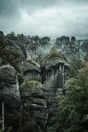 Misty fog mountains from viewpoint of Bastei in Saxon Switzerland, Germany to the mountains at sunrise in the morning fog, National park Saxon Switzerland