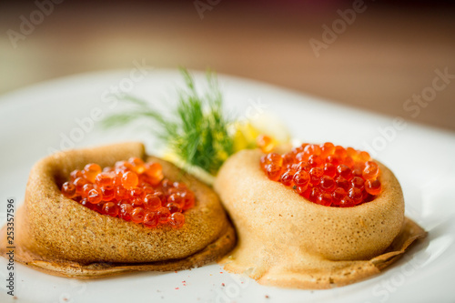 fresh pancakes with red caviar and oil