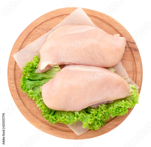  Raw chicken breast fillets on wooden cutting board isolated on white background