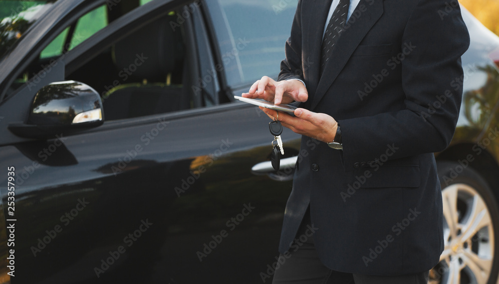 transport, business trip, technology and people concept - close up of young man with tablet pc computer and car outdoors