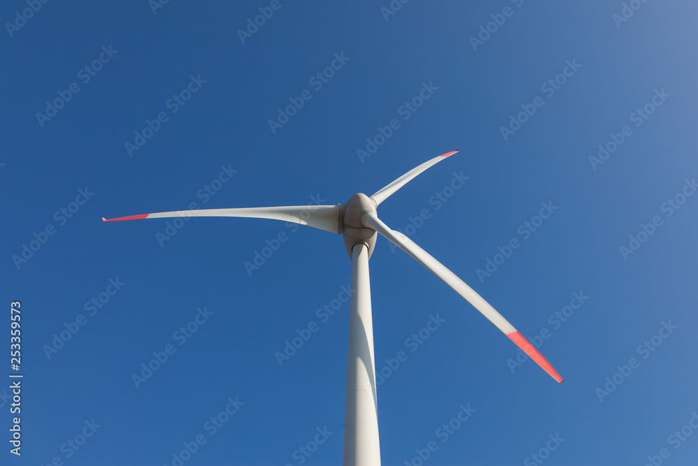 wind turbine with sun flare blue sky background view from below wind turbine with sun flare blue sky background view from below