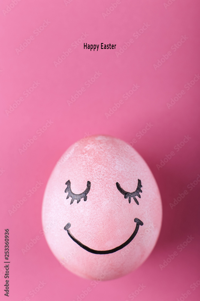 Pink egg with painted smiles. Happy Easter concept greeting card design.