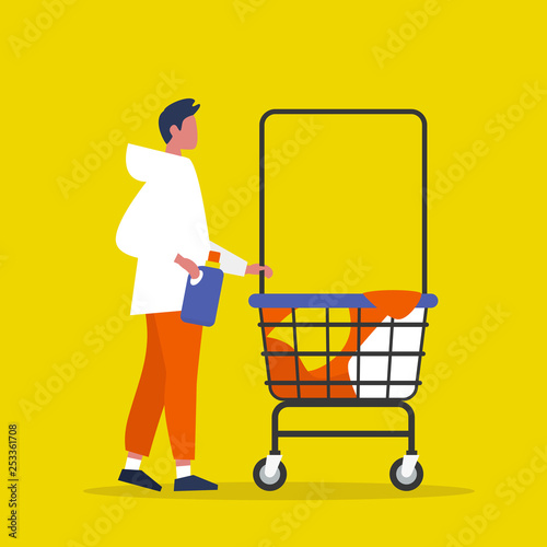 Colourful clothes in a trolley. Self service. Young male character rolling a laundry cart. Laundromat. Detergent. Daily chores concept.