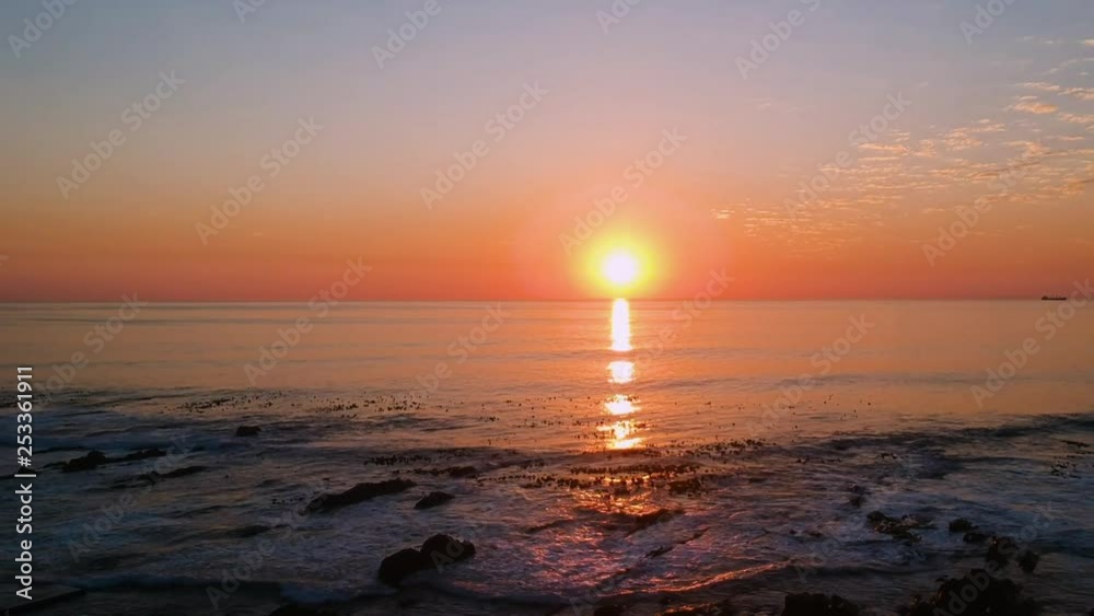 A high angle shot of the ocean during sunset. A high angle shot of the ocean during sunset.