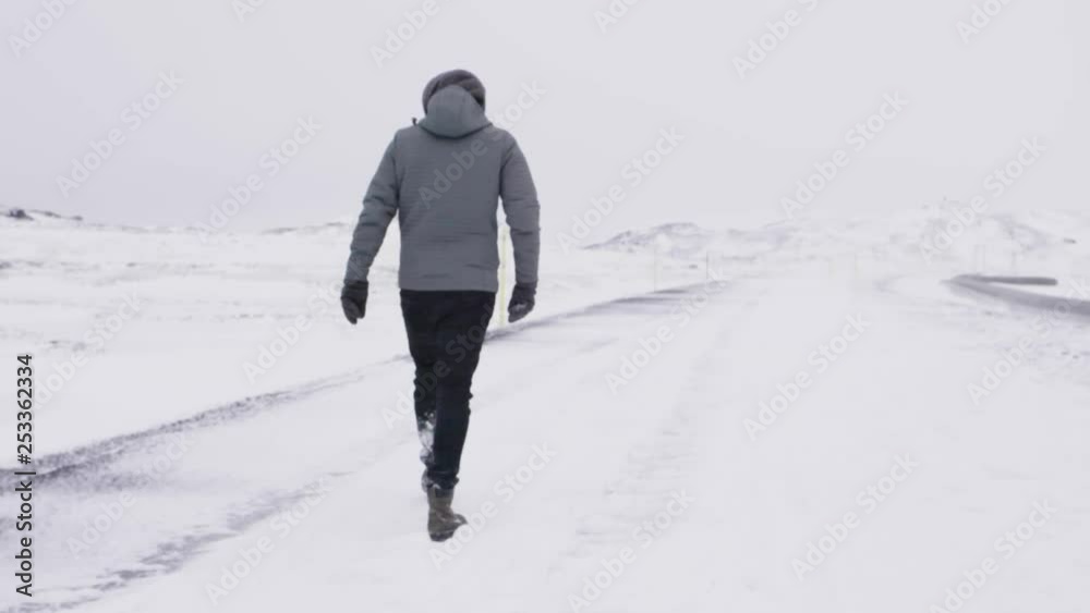 Young Male Traveler Walking through blizzard in slow motion Young Male Traveler Walking through blizzard in slow motion