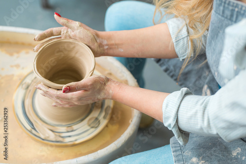 girl makes a jug of his own hands in a pottery workshop 