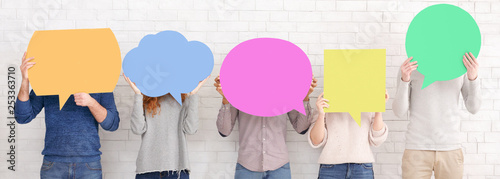 Friends holding speech bubbles with copy space photo