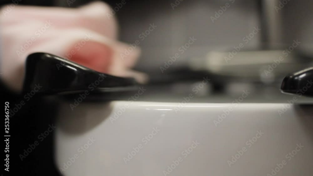 An industrial toilet bowl is cleaned with a swab and wiped An industrial toilet bowl is cleaned with a swab and wiped