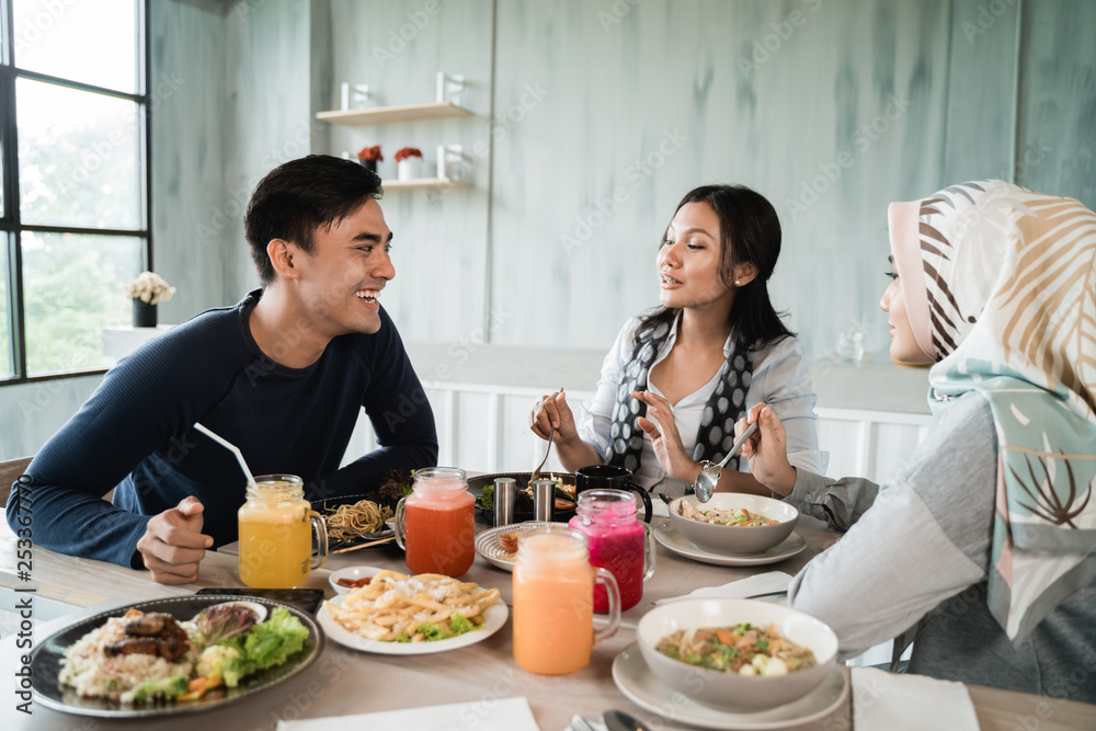 group of friends enjoy eating together in a restaurant