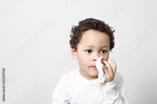 child blowing nose after catching a cold