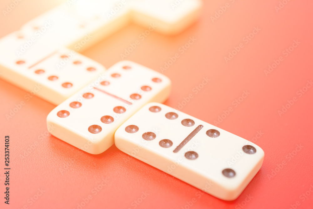 Dominoes on red table Dominoes on red table