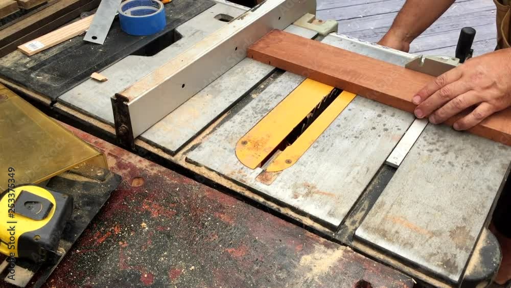 Table saw cutting grooves in mahogany board.
Saw blade set to half depth to cut grooves in wood.
Front high angle. Table saw cutting grooves in mahogany board.
Saw blade set to half depth to cut grooves in wood.
Front high angle.