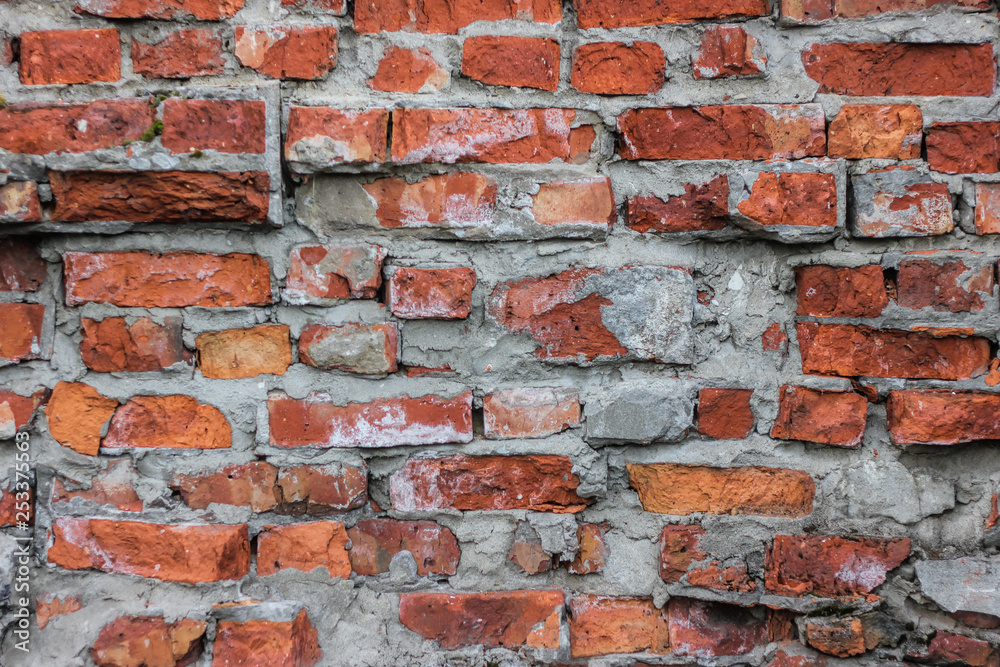 Old damaged red brick wall with cement joints, texture background, closeup. Old damaged red brick wall with cement joints, texture background, closeup.