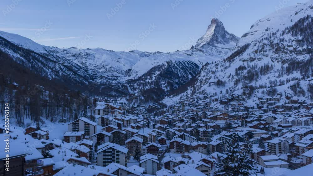 Zermatt Village and Matterhorn Mountain at Snowy Winter Morning. Swiss Alps, Switzerland. Night to Day Time Lapse