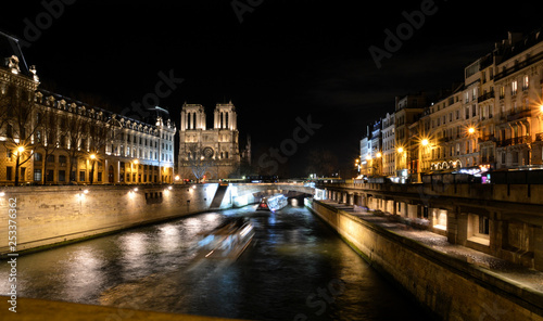 Paris by night, with the Seine and the barges