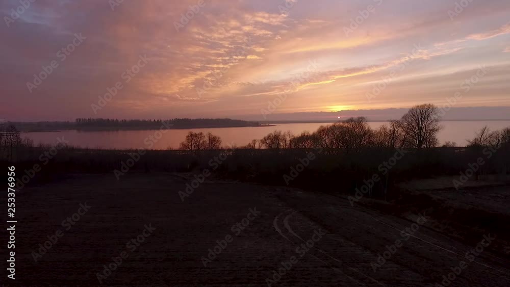 Lake Burtnieks in late autumn red sky sunset aerial wide view wit tree silhouette Lake Burtnieks in late autumn red sky sunset aerial wide view wit tree silhouette