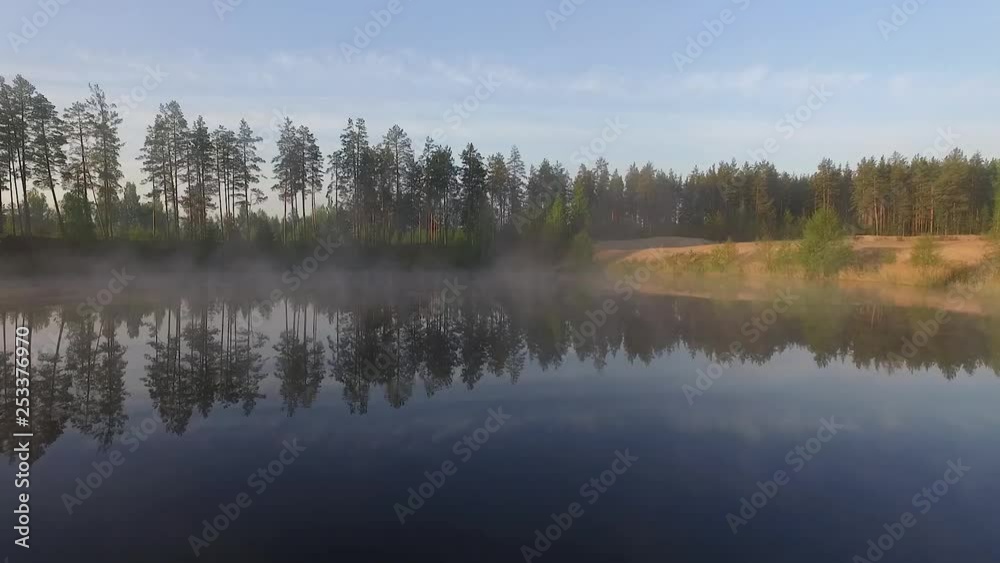 Misty morning sunlight over autumn forest lake and scenic countryside landscape aerial wide view Misty morning sunlight over autumn forest lake and scenic countryside landscape aerial wide view