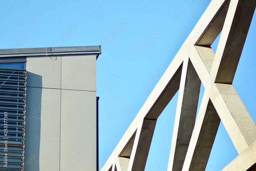 Abstract image of looking up at modern glass and concrete building. Architectural exterior detail of office building. Abstract image of looking up at modern glass and concrete building. Architectural exterior detail of office building.