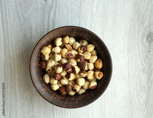 Healthy food for background image close up hazelnuts. Nuts texture on white grey table top view