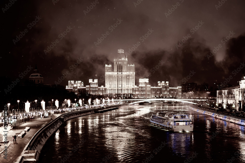Fototapeta premium Tourist steamboat on Moscow river, view of night city lights on embankment