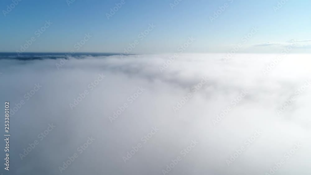 Flight over misty clouds in morning sunlight with little glory and city scape under clouds Flight over misty clouds in morning sunlight with little glory and city scape under clouds