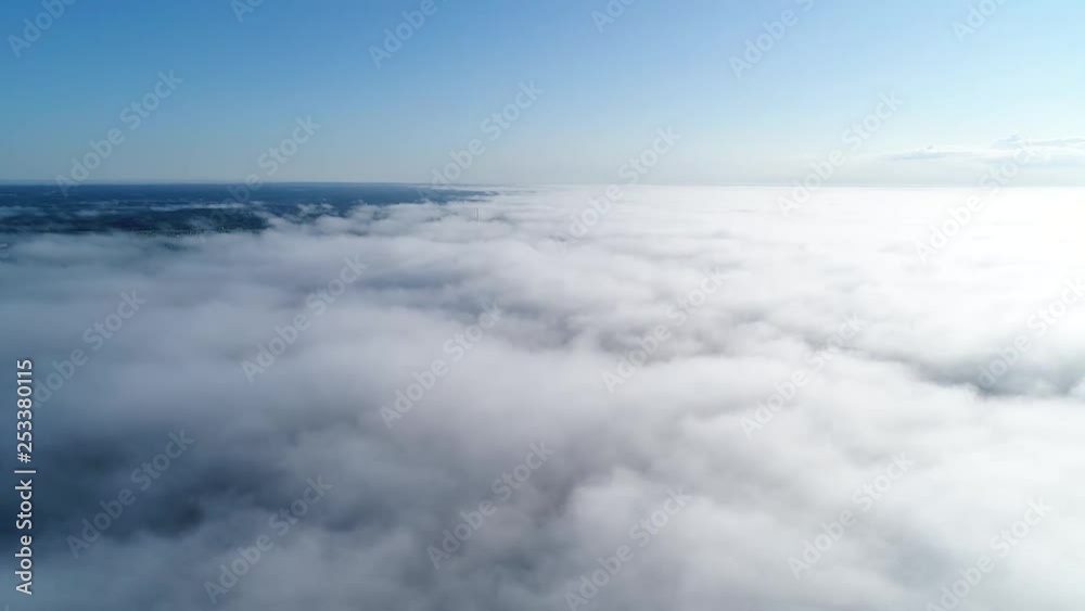 Flight over misty clouds in morning sunlight with little glory and city scape under clouds Flight over misty clouds in morning sunlight with little glory and city scape under clouds