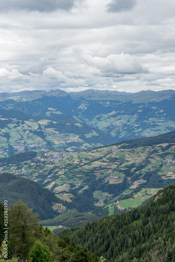 Naklejka premium Alpe di Siusi, Seiser Alm with Sassolungo Langkofel Dolomite, a view of a large mountain in the background