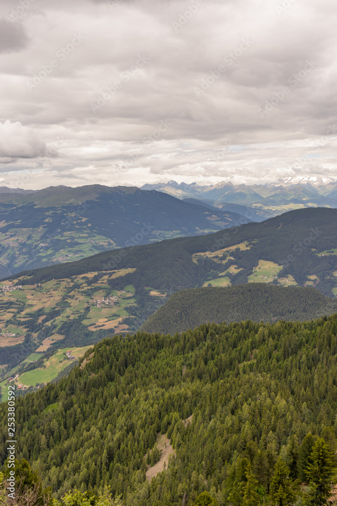 Naklejka premium Alpe di Siusi, Seiser Alm with Sassolungo Langkofel Dolomite, a view of a large mountain in the background