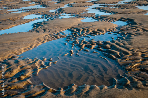 Pattern in the sand at low tide on the beach near Hunstanton, The Wash, Norfolk, England, UK photo