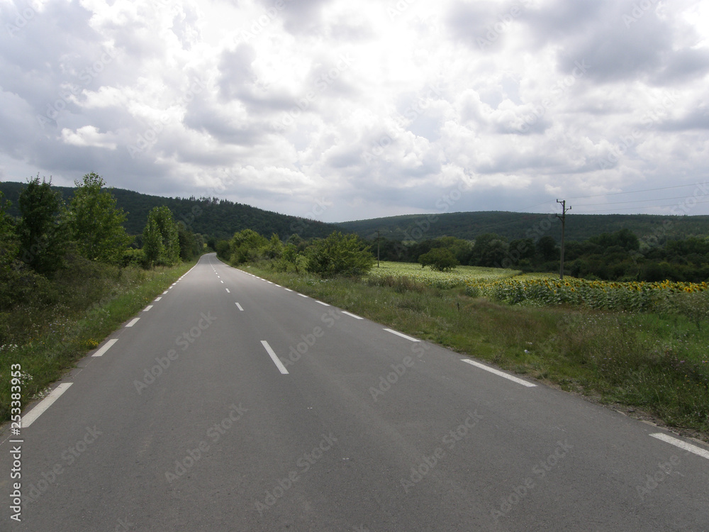 Empty Straight Road for Travel. Landscape of Mountains and Sky with Clouds. Empty Straight Road for Travel. Landscape of Mountains and Sky with Clouds.