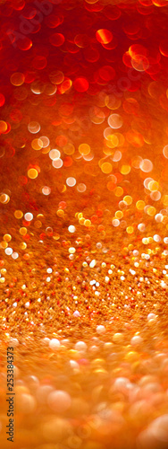 Blurred golden background  bokeh og glitters on fabric  Festive warm backdrop with copy space.