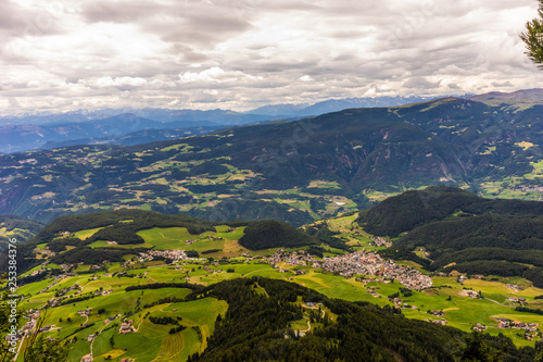 Fototapeta Naklejka Na Ścianę i Meble -  Alpe di Siusi, Seiser Alm with Sassolungo Langkofel Dolomite, a view of a lush green hillside