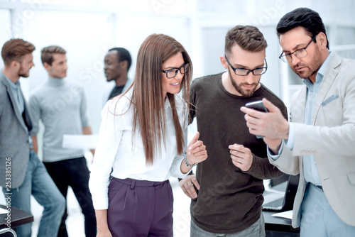 close up.group employee looking at the smartphone screen