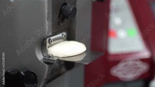 Close-up of a dough sample in a testing machine being prepared for flour quality assurance testing in the lab photo