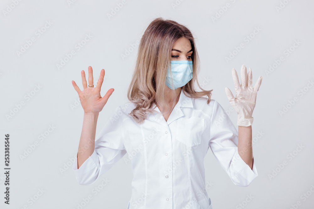 Portrait of woman doctor with face mask doctor shows hands. one gloved hand and the other without Portrait of woman doctor with face mask doctor shows hands. one gloved hand and the other without