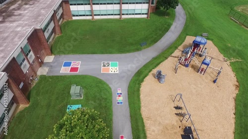 Aerial view of the palyground of an elementary school with swings and sand. photo