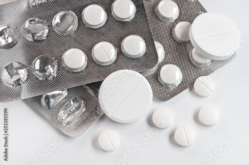 Pills on white table. Pharmacy concept