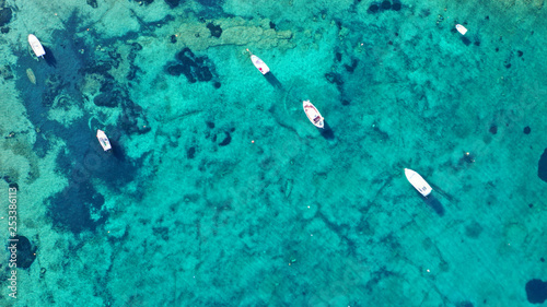 Aerial drone bird's eye photo of traditional fishing boat in island of Mykonos, Cyclades, Greece