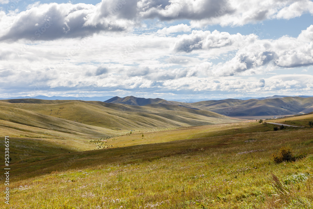 Mongolian steppe on the background of a cloudy sky, beautiful landscape. Mongolia