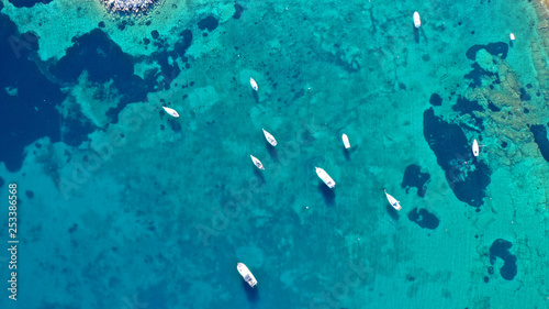Aerial drone bird's eye photo of traditional fishing boat in island of Mykonos, Cyclades, Greece