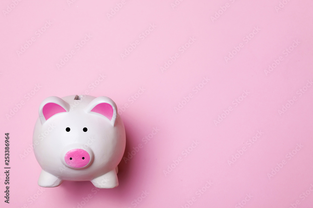 White piggy bank isolated on pink. Money saving background.