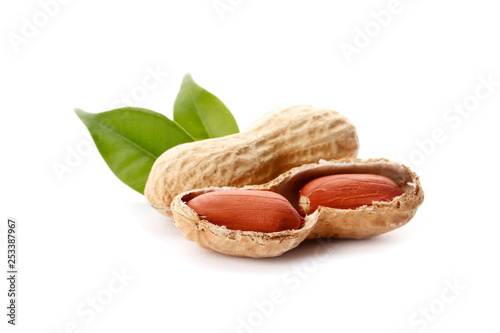 Raw peanuts on white background with green leaf. Healthy snack ona white background.Top view. close-up.